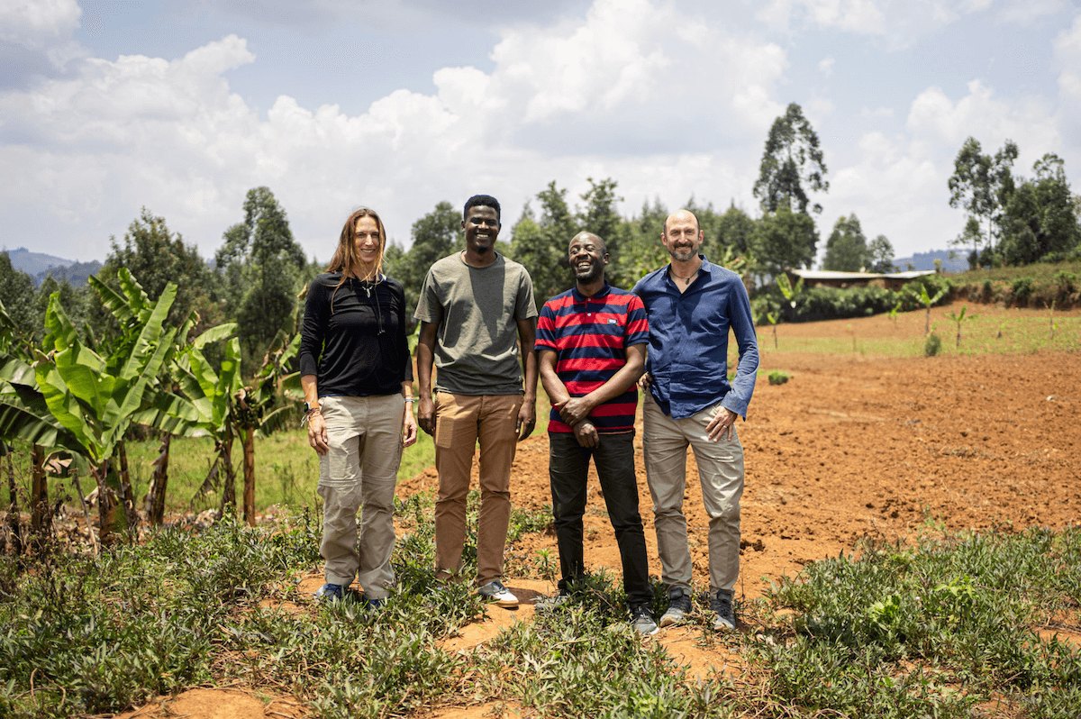 The RAIN team standing with portfolio founders in a field